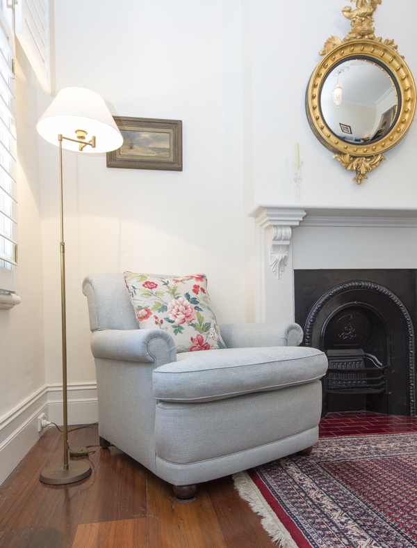 After - Reupholstered armchair with floral print accent cushion After - Reupholstered armchair with floral print accent cushion